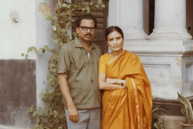 Dr ME Hoque and Dr AN Khanam standing outside their home